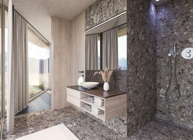 Luxuriöses Badezimmer mit Steinwand, offenem Duschbereich, Waschtisch mit runder Schale und Panoramablick